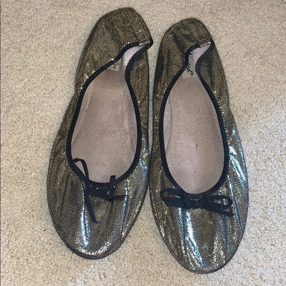 Gold sparkle flats with black bow at toe